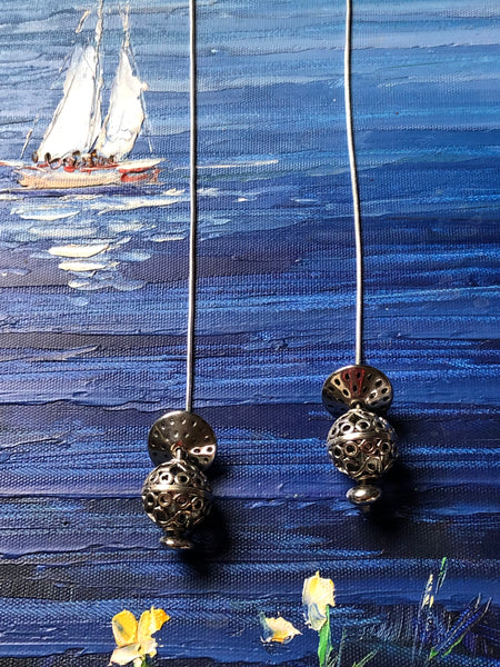 silver laminated finish pendant balls on long snake rope chain.